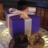 A royal purple gift box of cookies and brownies