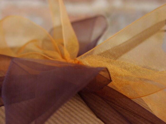 This large gift box features a brown ribbon with gold accent