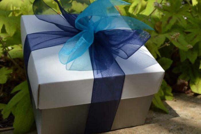 Silver gift box of gourmet cookies and brownies with a blue ribbon