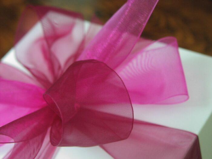 Silver gift box of gourmet cookies with a bright pink ribbon