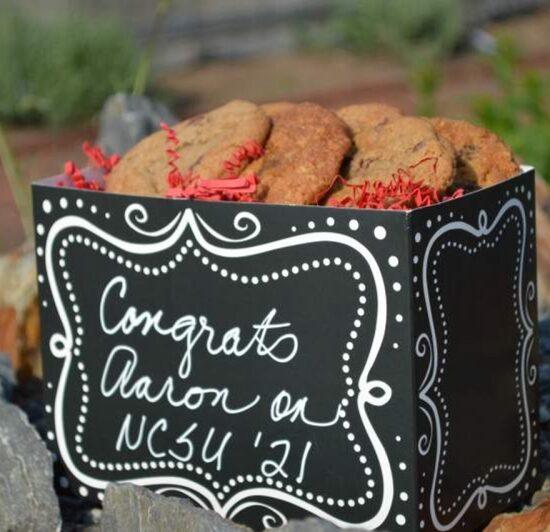 A large custom gift basket of gourmet cookies with a hand-written message